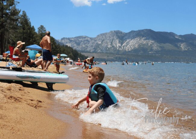 A kid giggling with delight while splashing and playing with the refreshing water, creating memories by the serene shores of Pope beach.