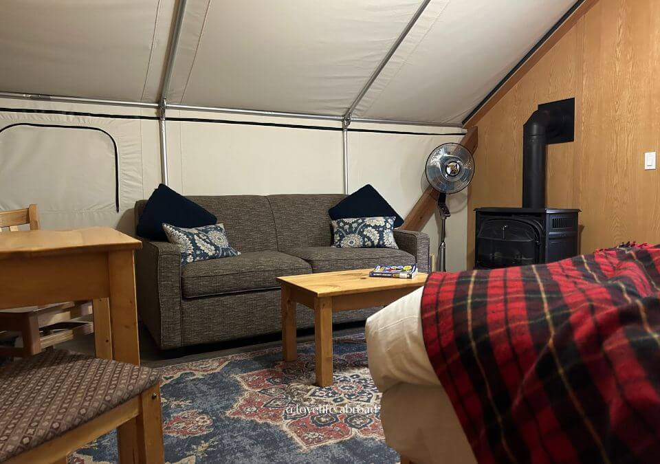 the inside of the glamping tent you can find a log fireplace