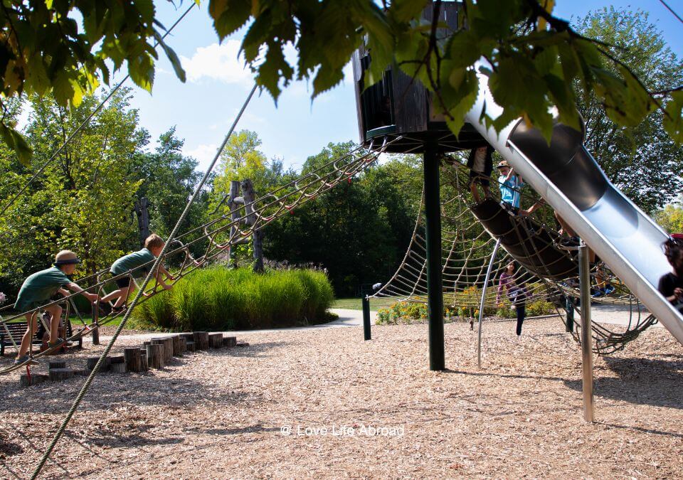 Kids climbing the slide at the nature playground at Assiniboine Park in Winnipeg