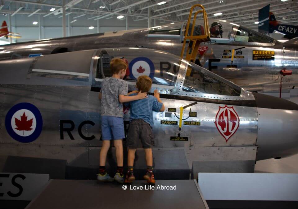 Kids looking inside a plane at the Royal Aviation Museum in Winnipeg